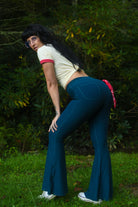 Women’s high waisted blue flared pants with dramatic bell bottom legs
