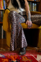 Desert Rattler 70s inspired flare pants with rattlesnake print
